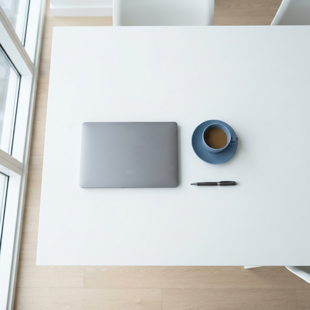 Minimalist desk setup with laptop and coffee cup