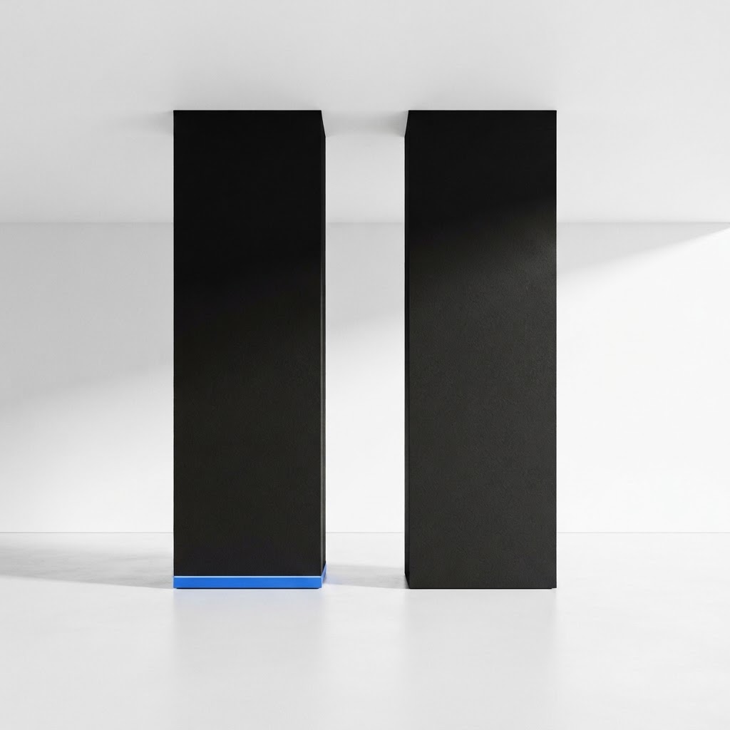 Two architectural black pillars with a blue trim detail on a white floor