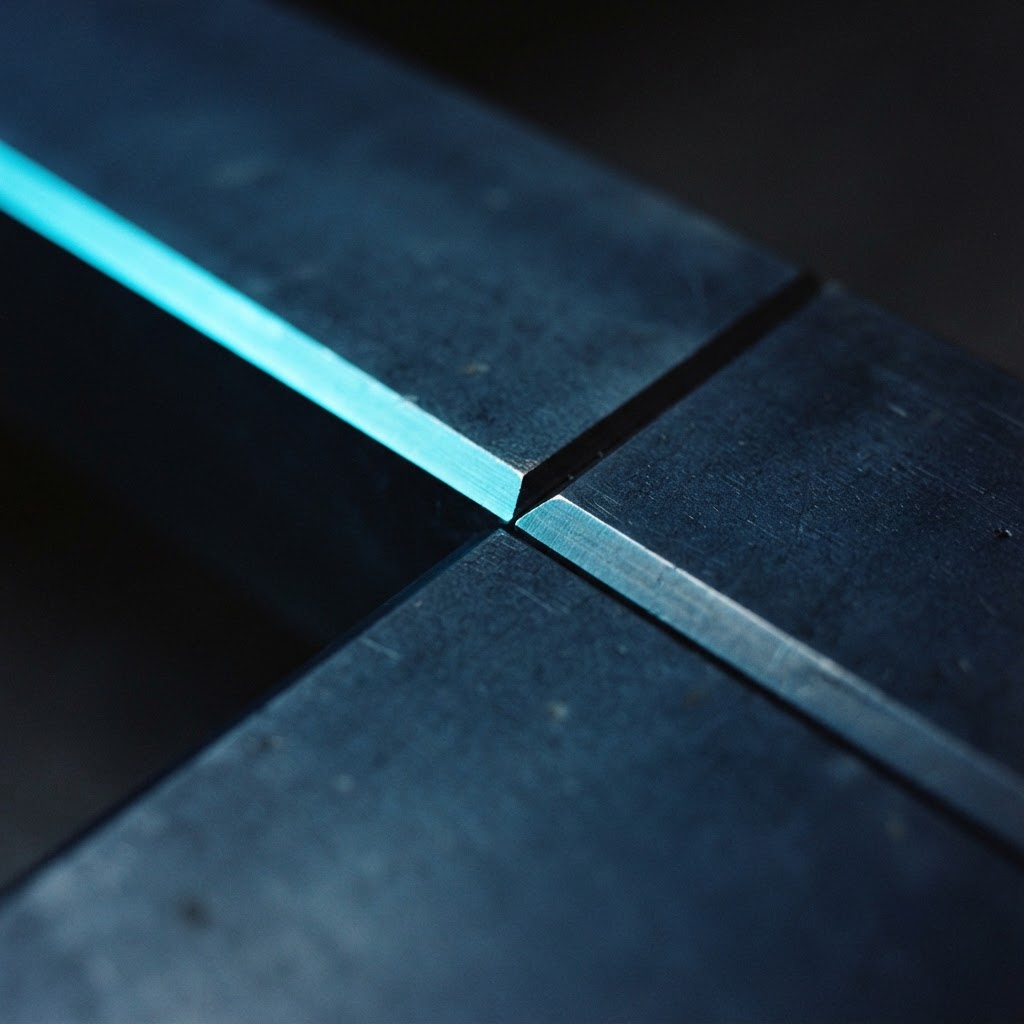 Close up detail of matte navy steel plates with sharp cyan highlights